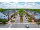 Symmetrical street view featuring well-maintained townhomes and mature trees lining the roadway at 240 Swann Trl, Clayton, NC 27527
