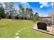 Large, well-manicured backyard with a wooden deck and a barbecue grill, perfect for outdoor entertaining at 245 Naples Ln, Clayton, NC 27527