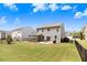 Spacious backyard with a wooden deck, patio area, and lush green lawn at 245 Naples Ln, Clayton, NC 27527