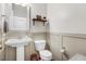 Powder room with a pedestal sink and decorative shelf at 245 Naples Ln, Clayton, NC 27527