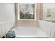 A serene bathroom with a soaking tub and a large window offering a peaceful view at 245 Naples Ln, Clayton, NC 27527