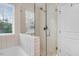 Bathroom featuring a glass enclosed shower, tub and a window that brings in natural light at 245 Naples Ln, Clayton, NC 27527
