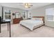 The bedroom has carpeted floors, a ceiling fan and a large window at 245 Naples Ln, Clayton, NC 27527