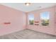 Light-filled bedroom with pink walls and neutral carpet at 245 Naples Ln, Clayton, NC 27527