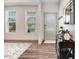 Inviting entryway boasting a decorative mirror, hall tree, and luxury vinyl plank flooring at 245 Naples Ln, Clayton, NC 27527
