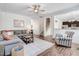 Open living area featuring hardwood floors, a comfortable sectional sofa, and an adjacent staircase at 245 Naples Ln, Clayton, NC 27527