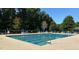 A community pool featuring a clear blue swimming area and lounge chairs for relaxation at 245 Naples Ln, Clayton, NC 27527