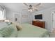 Bedroom showcasing a queen bed with decorative pillows, a ceiling fan and an ensuite bathroom at 25 S Treeline Dr, Spring Hope, NC 27882
