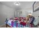 Bedroom showcasing a bed with a colorful quilt, neutral walls, and two entry doors at 25 S Treeline Dr, Spring Hope, NC 27882