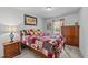 Bedroom featuring a wood bedframe with a patchwork quilt, a bedside table, and a chest of drawers at 25 S Treeline Dr, Spring Hope, NC 27882