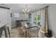 Charming dining area with views of the backyard, complemented by stylish chandelier and curated decor at 25 S Treeline Dr, Spring Hope, NC 27882
