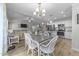 Bright dining area with backyard views, stylish chandelier, and seamless open access to the kitchen and living room at 25 S Treeline Dr, Spring Hope, NC 27882