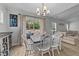 Bright dining area with modern lighting, slider to outdoor seating area, and stylish transitional design at 25 S Treeline Dr, Spring Hope, NC 27882