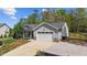 Beautifully landscaped home with a well-maintained lawn, driveway, and attached two car garage at 25 S Treeline Dr, Spring Hope, NC 27882