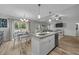 Open concept kitchen with island featuring granite countertops, stainless steel appliances, and views into the living area at 25 S Treeline Dr, Spring Hope, NC 27882