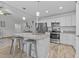 Modern kitchen features an island with granite countertops, a breakfast bar, stainless appliances, and white cabinets at 25 S Treeline Dr, Spring Hope, NC 27882