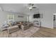 Bright living room featuring a comfortable sectional sofa, neutral decor, and modern entertainment center at 25 S Treeline Dr, Spring Hope, NC 27882