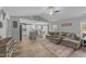 Open-concept living room featuring a large sectional sofa, modern ceiling fan, and a view of the kitchen at 25 S Treeline Dr, Spring Hope, NC 27882