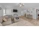 Spacious living room featuring a sectional sofa, entertainment center, and seamless transition to the kitchen at 25 S Treeline Dr, Spring Hope, NC 27882