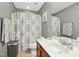 Inviting bathroom features a single vanity, decorative shower curtain, and fresh white finishes at 2728 Cloud Mist Cir, Raleigh, NC 27614