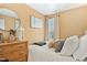 Charming bedroom featuring a cozy daybed, natural light, and a decorative round mirror at 2728 Cloud Mist Cir, Raleigh, NC 27614