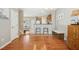 Open dining area with kitchen bar, and hardwood floors leading to the living area at 2728 Cloud Mist Cir, Raleigh, NC 27614