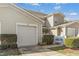 Inviting townhome with a one-car garage, manicured bushes, and a charming bench at 2728 Cloud Mist Cir, Raleigh, NC 27614