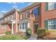Brick townhome with front lawn, brown shutters and neat landscaping, creating curb appeal at 2728 Cloud Mist Cir, Raleigh, NC 27614