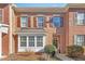 Brick townhome with brown shutters, bay window, and a welcoming front entrance with a wreath decor at 2728 Cloud Mist Cir, Raleigh, NC 27614