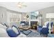 Inviting living room with hardwood floors, lit fireplace, and bright natural light at 2728 Cloud Mist Cir, Raleigh, NC 27614
