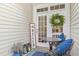 Cozy patio with seating, a decorative wreath, and a welcoming 