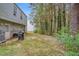Spacious backyard area featuring lush greenery, trees, and side of home at 2816 Delco Ct, Raleigh, NC 27610