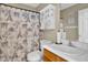 Charming bathroom featuring a decorative Paris shower curtain, storage cabinet, and wood vanity at 2816 Delco Ct, Raleigh, NC 27610