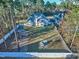 Aerial backyard view featuring a well-maintained lawn and fenced-in yard with mature trees at 286 Sea Mist Dr, Sanford, NC 27332