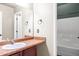 Bright bathroom featuring a single sink vanity with faux marble countertop and a shower with a white showerhead at 286 Sea Mist Dr, Sanford, NC 27332
