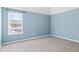 Blue-walled bedroom with carpet flooring, large window and white trim at 286 Sea Mist Dr, Sanford, NC 27332