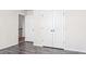 Bedroom with wood-look flooring, white trim, and closet access at 286 Sea Mist Dr, Sanford, NC 27332