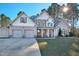 Inviting two-story home features a two-car garage, manicured lawn, and a covered front porch with stone accents at 286 Sea Mist Dr, Sanford, NC 27332
