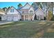 Inviting two-story home features a two-car garage, manicured lawn, and a covered front porch with stone accents at 286 Sea Mist Dr, Sanford, NC 27332