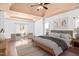 Main bedroom with tray ceiling, ceiling fan, and plenty of natural light at 286 Sea Mist Dr, Sanford, NC 27332