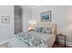 Cozy bedroom featuring a queen-sized bed, bedside table, and neutral walls with decorative artwork at 317 W Morgan St # 317, Raleigh, NC 27601