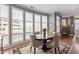Bright dining room with large windows, custom shutters, hardwood floors, and elegant furnishings at 317 W Morgan St # 317, Raleigh, NC 27601