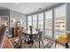 Bright dining area featuring hardwood floors, large windows with natural light and elegant seating for four at 317 W Morgan St # 317, Raleigh, NC 27601