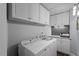 Well-organized laundry room with ample cabinet space, a washer, and a dryer at 317 W Morgan St # 317, Raleigh, NC 27601