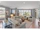 Bright living room featuring hardwood floors, large windows, comfortable seating, and a stylish area rug at 317 W Morgan St # 317, Raleigh, NC 27601