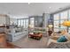 Open-concept living room with hardwood floors, a comfortable seating arrangement and access to the kitchen and dining area at 317 W Morgan St # 317, Raleigh, NC 27601