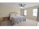Cozy bedroom featuring a comfortable bed, natural light from windows, and ceiling fan at 323 E Stratford Dr, Henderson, NC 27537