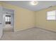 Inviting bedroom with plush carpet and adjacent room view, and natural light at 323 E Stratford Dr, Henderson, NC 27537