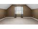 Bright bedroom featuring large window and plush carpeting, with natural light at 323 E Stratford Dr, Henderson, NC 27537