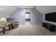 Comfortable bonus room with plush carpeting, recliner, tv, and ample space at 323 E Stratford Dr, Henderson, NC 27537